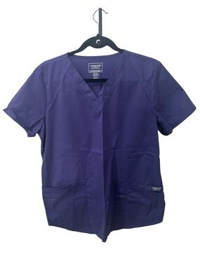 Cherokee Workwear V-neck scrub top is shown in a grape purple women size M